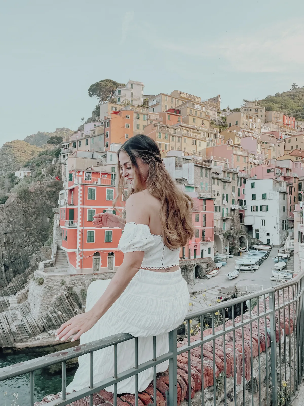 Sarah looking out over a cliffside coastal village in Cinque Terre